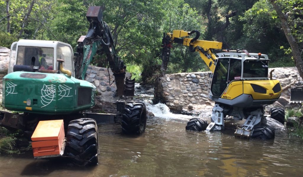 Spider excavators remove on dam on San Juan Creek in California's Cleveland National Forest.